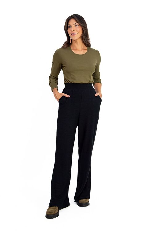 Modelo vestindo calça pantalona preta texturizada com blusa verde oliva, vista frontal.
